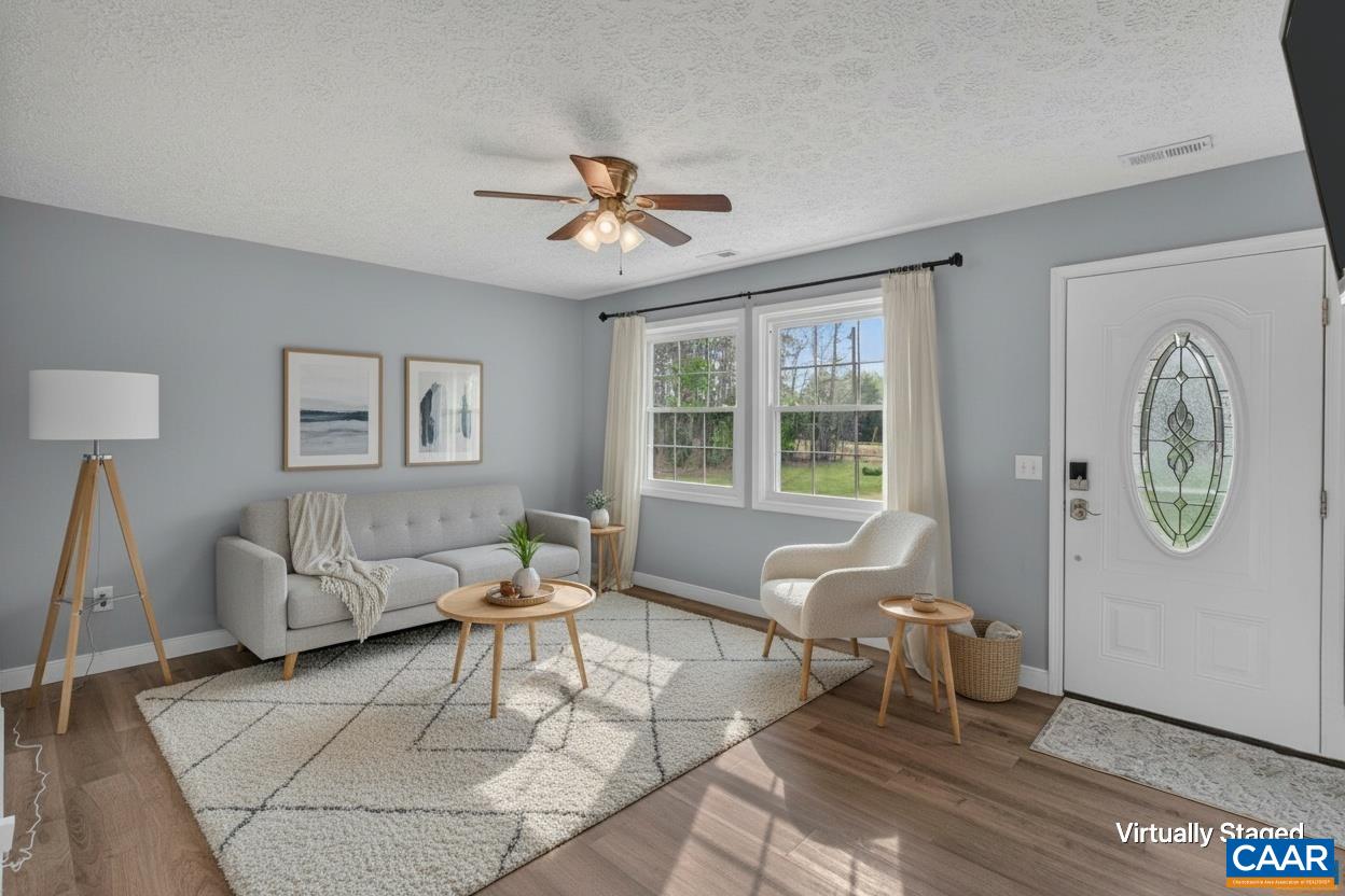 673 Cedar Lane Road Palmyra, VA 22963 - Photo 7 of 47 a living room with furniture a rug a lamp and a window