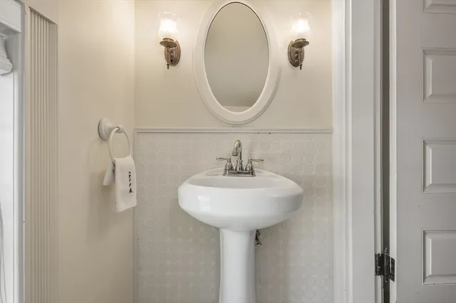 a bathroom with a sink a mirror and a light fixture