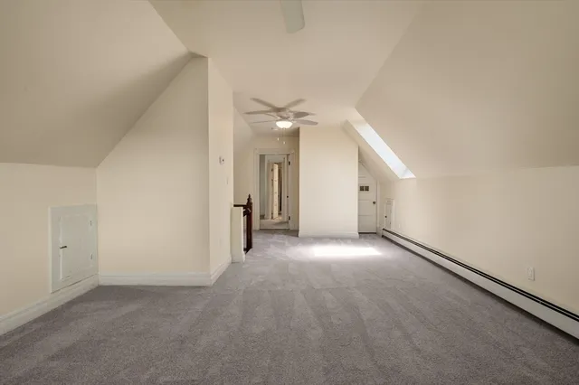 a view of an empty room with a ceiling fan