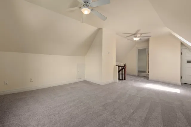 an empty room with a ceiling fan and a window