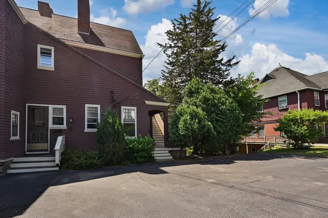 a front view of a house with a garden