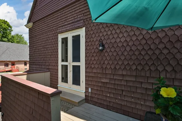 a view of balcony with furniture and umbrella