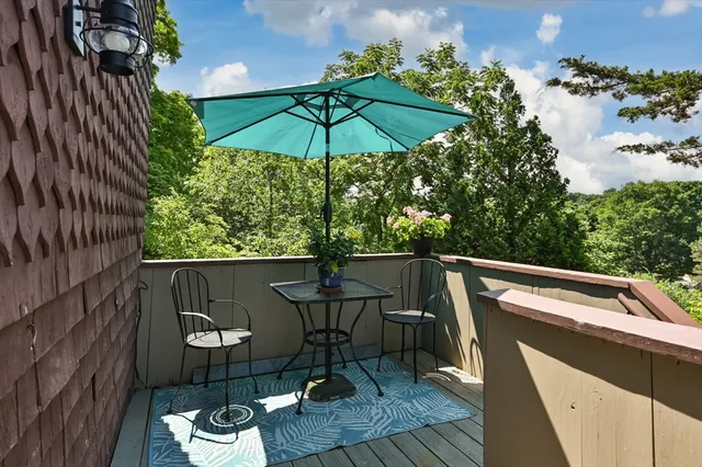 a view of roof deck with furniture and barbeque oven