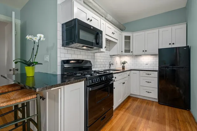 a kitchen with stainless steel appliances a stove microwave and refrigerator