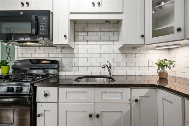 a kitchen with stainless steel appliances a sink stove and microwave