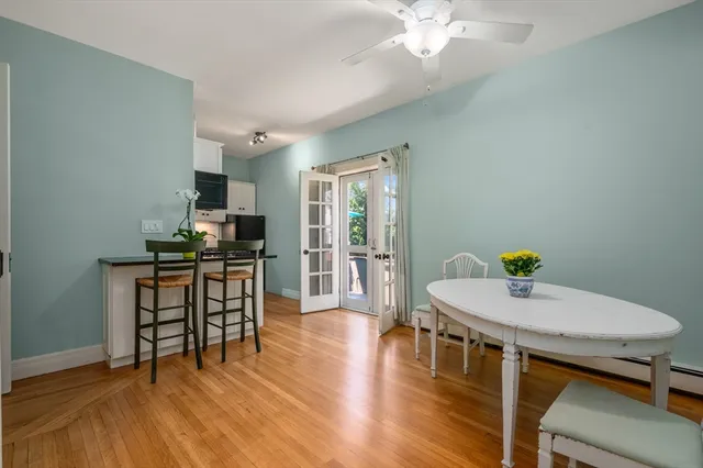 a dining room with furniture and wooden floor