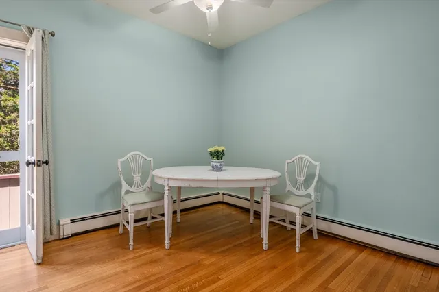 a view of a workspace with furniture and wooden floor