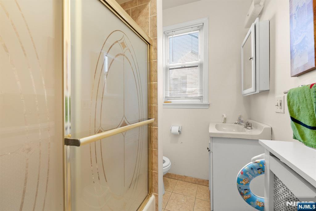 91 Headley Terrace Irvington, NJ 07111 - Photo 12 of 50 a bathroom with a sink a toilet and vanity