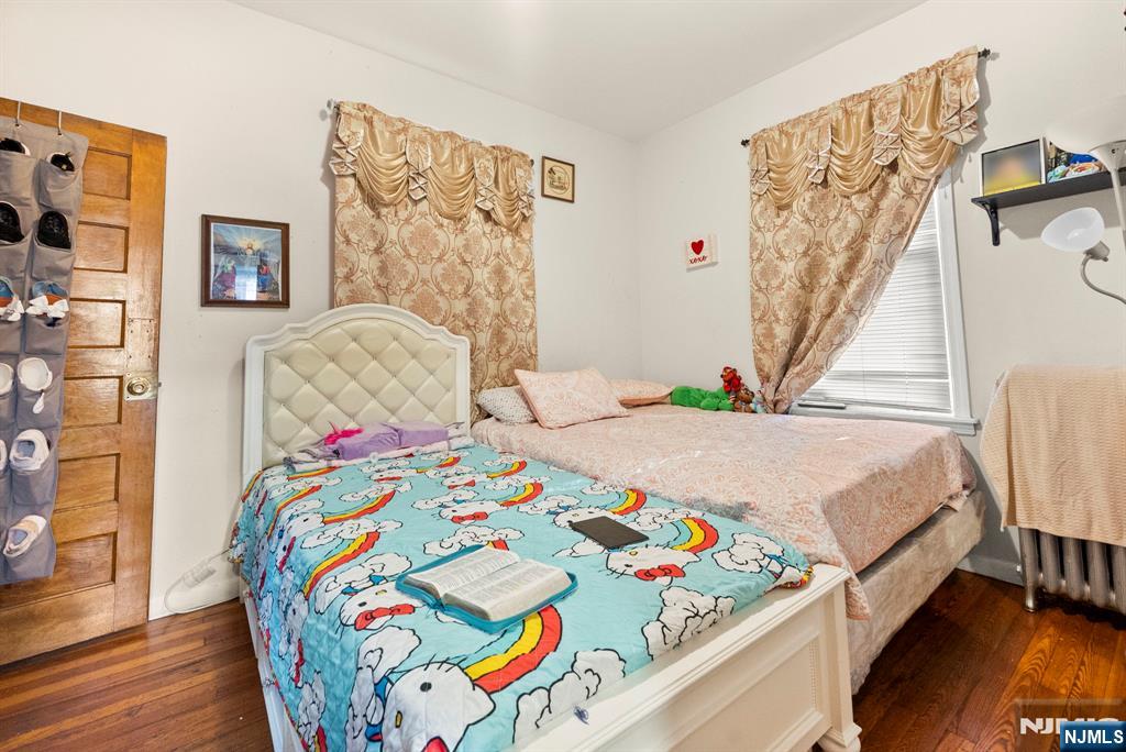 91 Headley Terrace Irvington, NJ 07111 - Photo 13 of 50 a bedroom with a bed and a painting on the wall