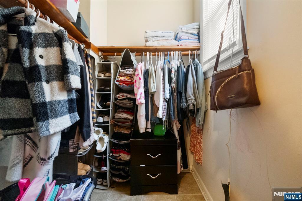 91 Headley Terrace Irvington, NJ 07111 - Photo 15 of 50 a view of walk in closet with clothes and shoes