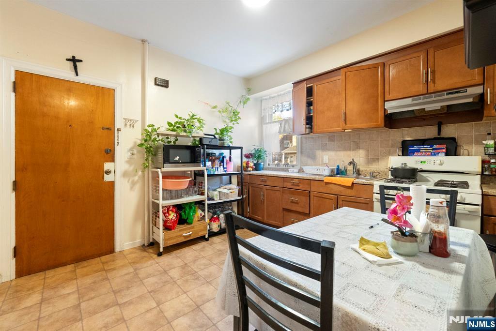 91 Headley Terrace Irvington, NJ 07111 - Photo 18 of 50 a view of kitchen and dining room with furniture