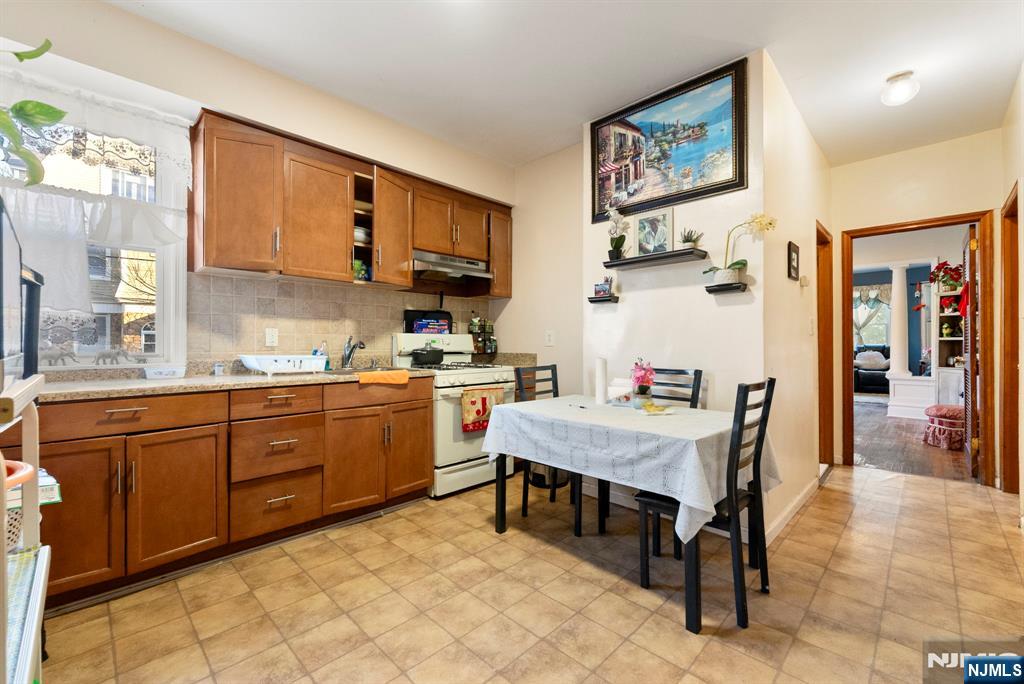 91 Headley Terrace Irvington, NJ 07111 - Photo 19 of 50 a room with kitchen island granite countertop furniture and a kitchen view