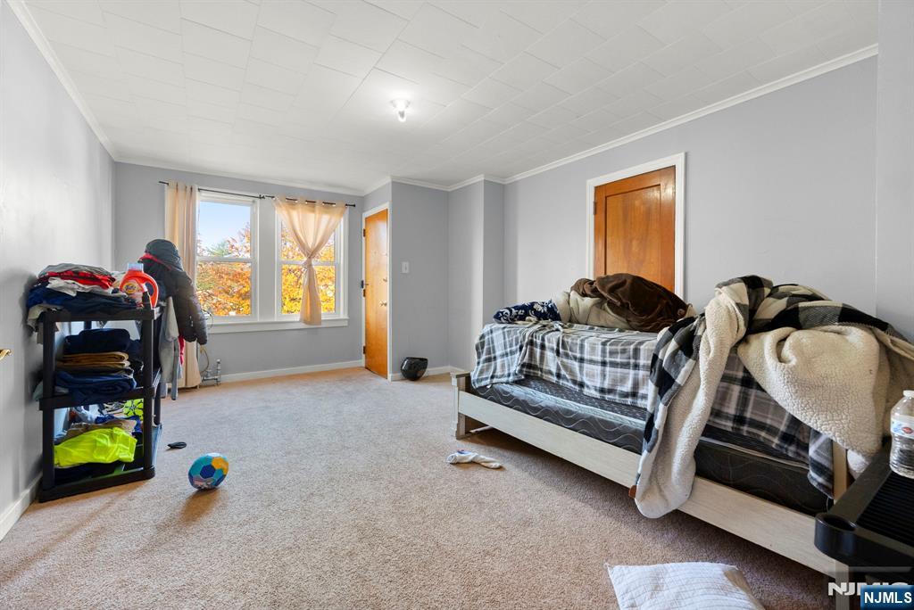 91 Headley Terrace Irvington, NJ 07111 - Photo 21 of 50 a bedroom with furniture and a window