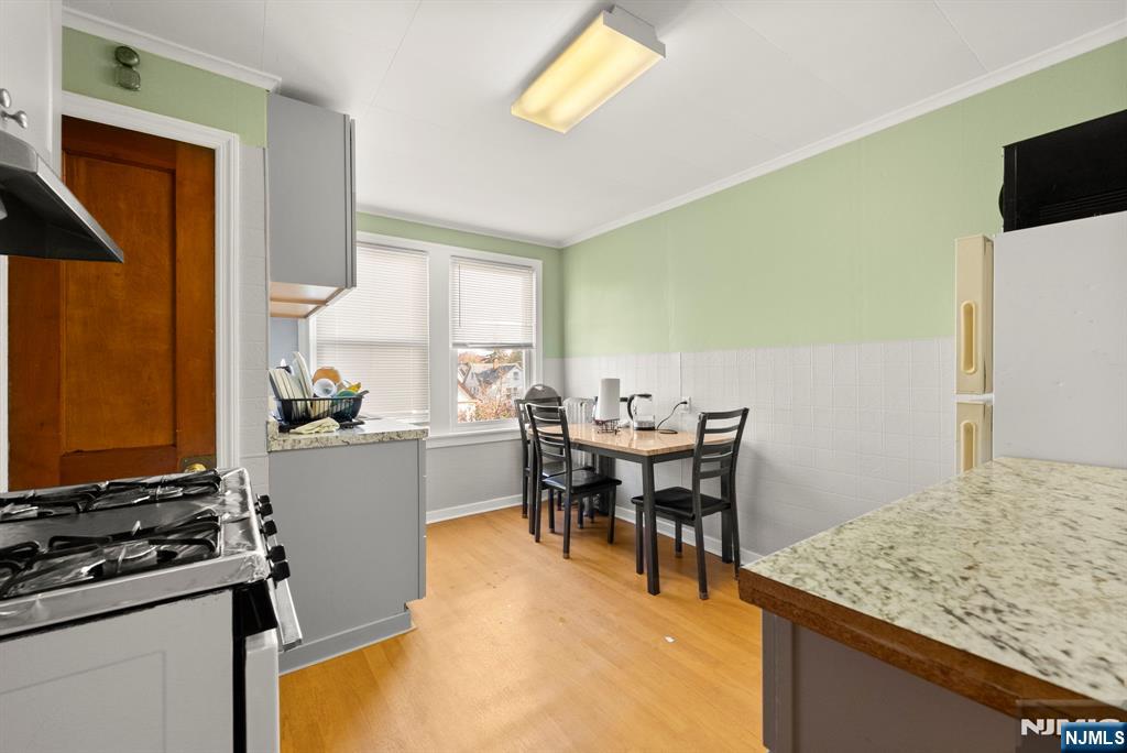 91 Headley Terrace Irvington, NJ 07111 - Photo 23 of 50 a kitchen with a table and chairs in it
