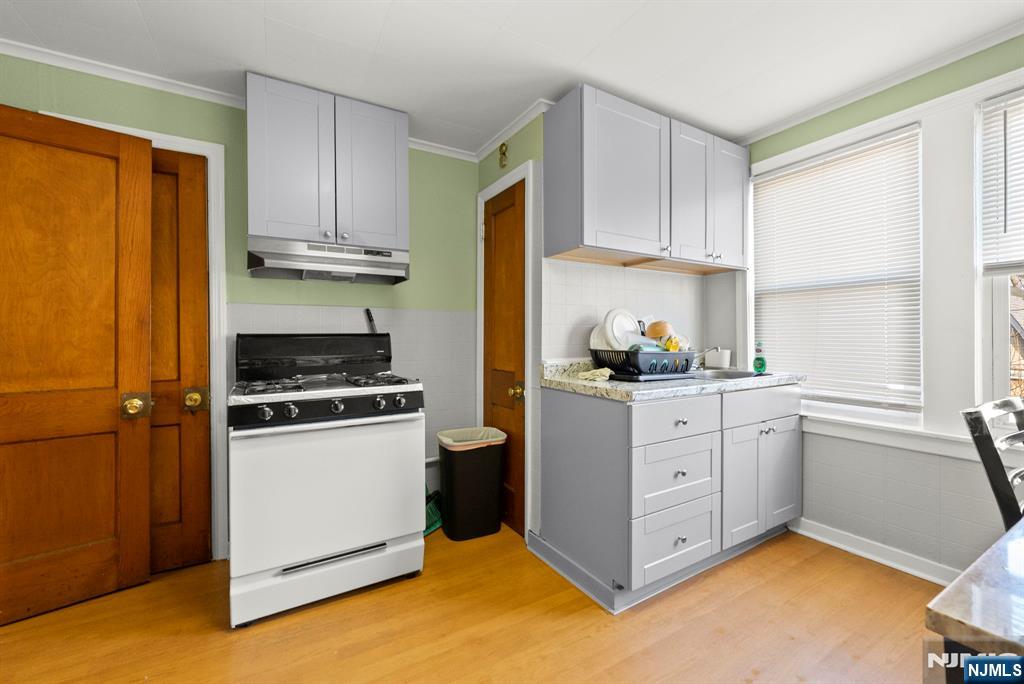 91 Headley Terrace Irvington, NJ 07111 - Photo 24 of 50 a kitchen with white cabinets and white appliances