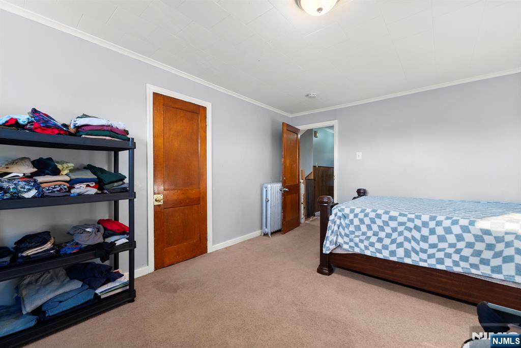 91 Headley Terrace Irvington, NJ 07111 - Photo 27 of 50 a bedroom with a bed and closet