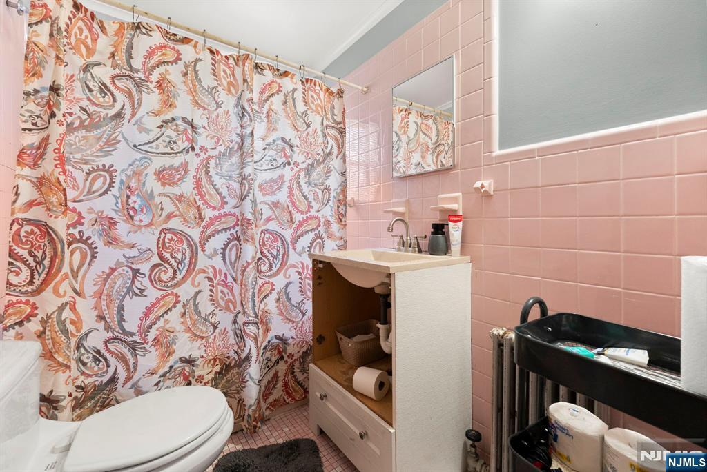 91 Headley Terrace Irvington, NJ 07111 - Photo 28 of 50 a bathroom with a sink toilet and a mirror