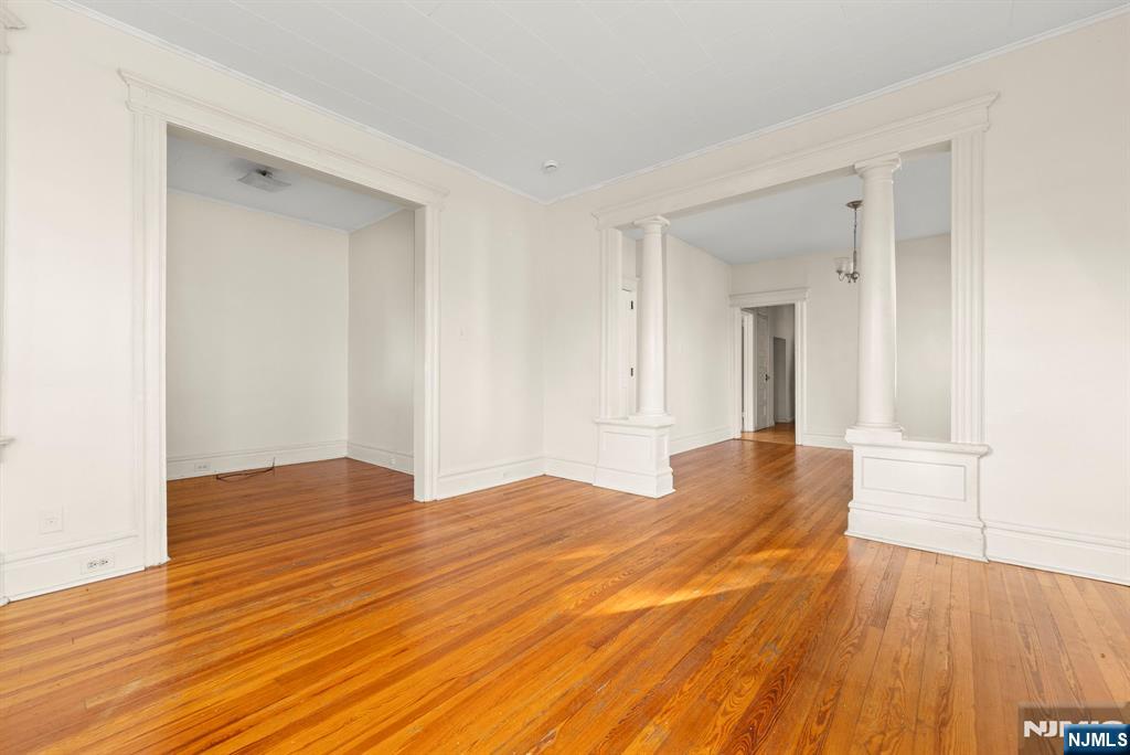 91 Headley Terrace Irvington, NJ 07111 - Photo 32 of 50 a view of empty room with wooden floor and fan