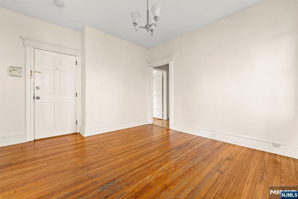 91 Headley Terrace Irvington, NJ 07111 - Photo 33 of 50 a view of an empty room with wooden floor