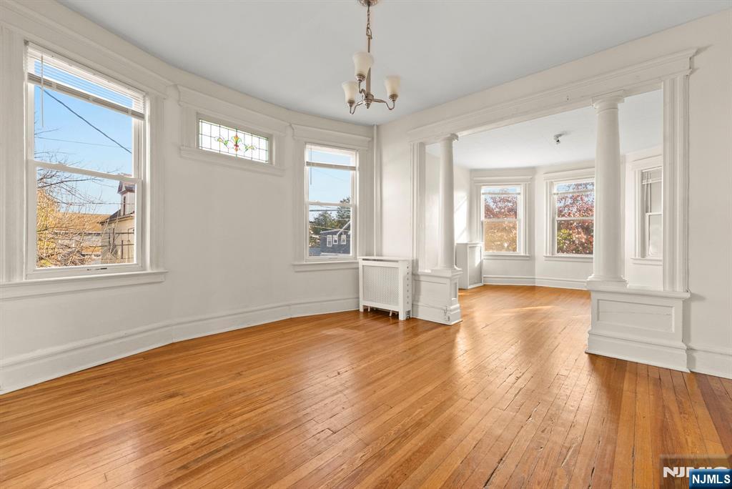 91 Headley Terrace Irvington, NJ 07111 - Photo 34 of 50 a view of an empty room with wooden floor and a window