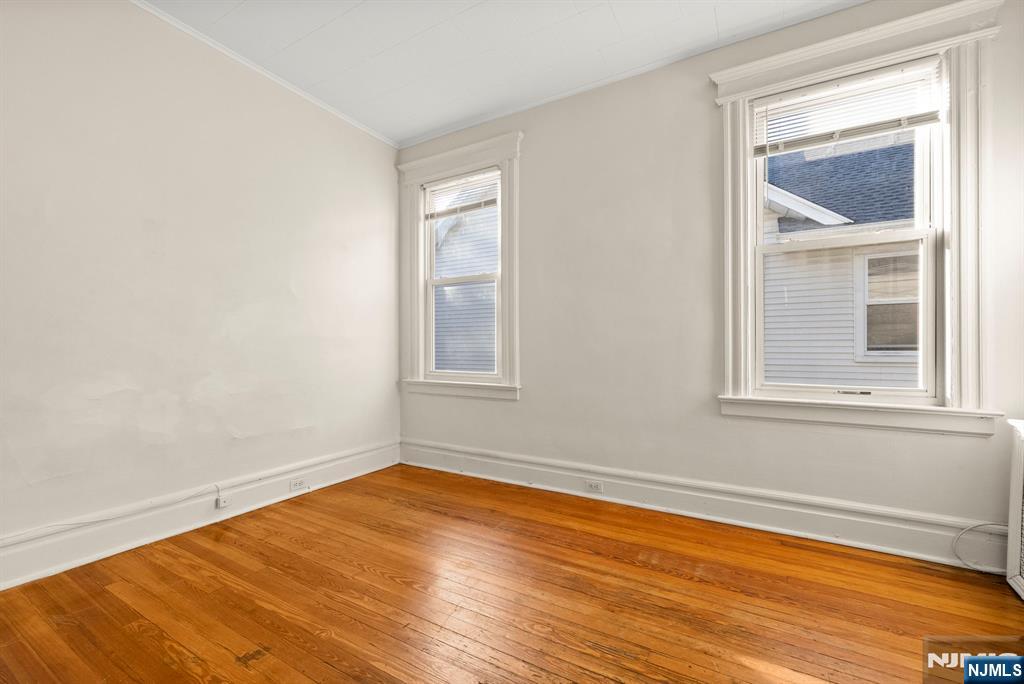 91 Headley Terrace Irvington, NJ 07111 - Photo 35 of 50 a view of empty room with wooden floor and fan
