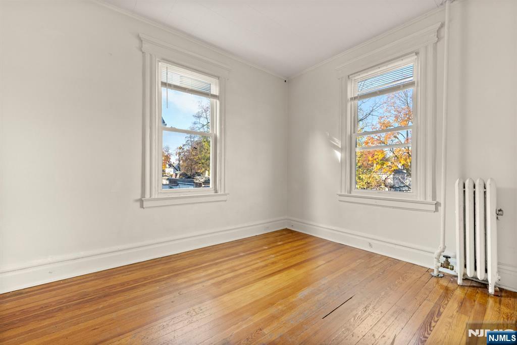 91 Headley Terrace Irvington, NJ 07111 - Photo 38 of 50 a view of an empty room with wooden floor and a window