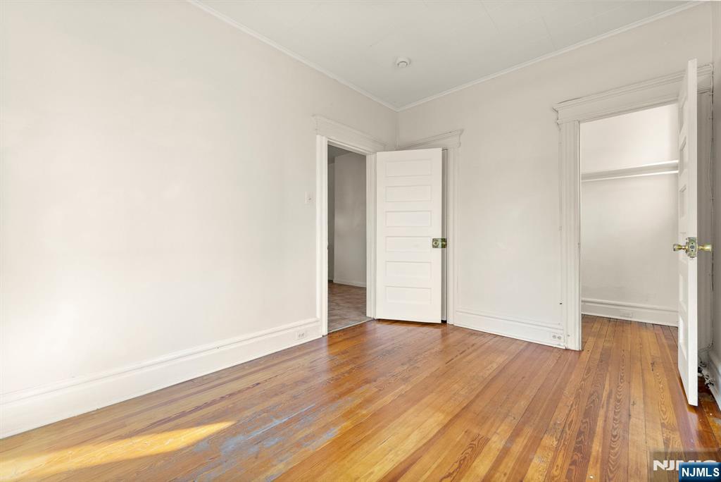 91 Headley Terrace Irvington, NJ 07111 - Photo 39 of 50 a view of an empty room with wooden floor