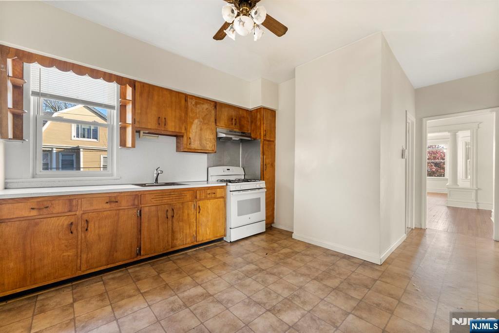 91 Headley Terrace Irvington, NJ 07111 - Photo 40 of 50 a kitchen with granite countertop a sink cabinets and stainless steel appliances