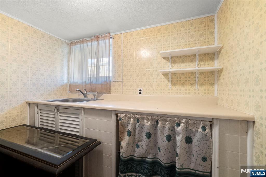 91 Headley Terrace Irvington, NJ 07111 - Photo 45 of 50 a bathroom with a sink and a mirror
