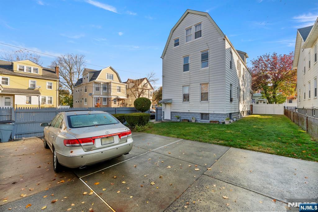91 Headley Terrace Irvington, NJ 07111 - Photo 48 of 50 a view of a small white car is parked in front of a brick house
