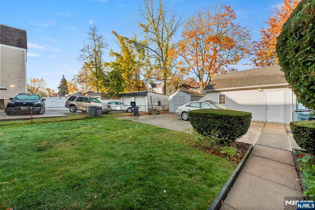 91 Headley Terrace Irvington, NJ 07111 - Photo 50 of 50 a view of a backyard with table and chairs and a fire pit