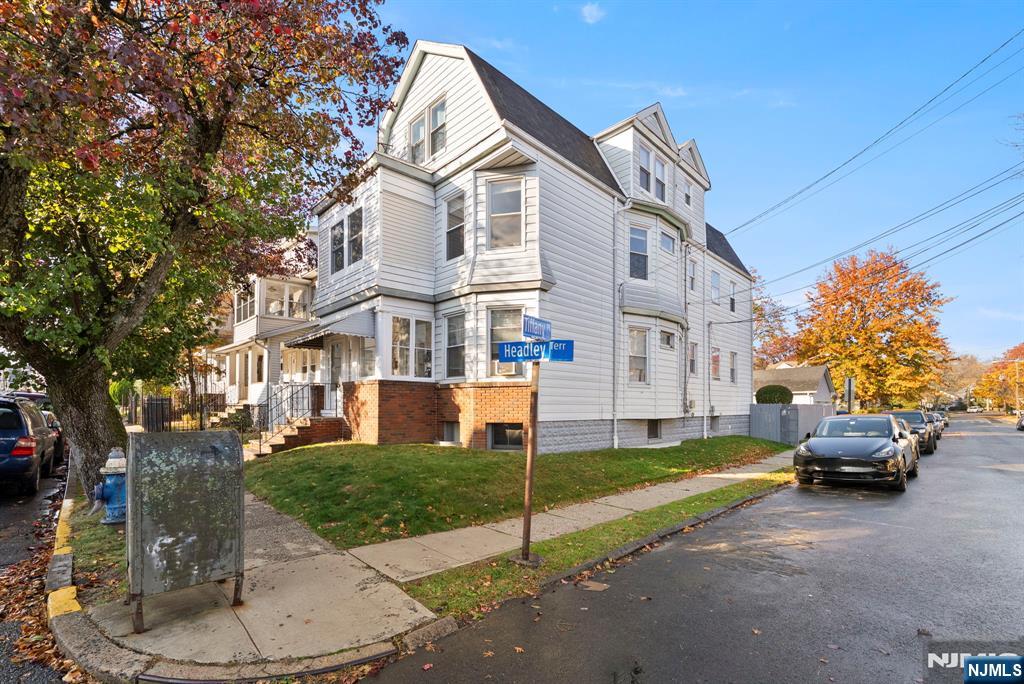91 Headley Terrace Irvington, NJ 07111 - Photo 5 of 50 a view of a white house next to a yard with big trees