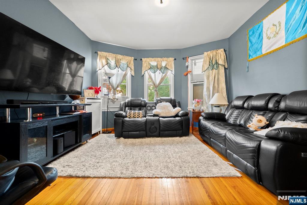 91 Headley Terrace Irvington, NJ 07111 - Photo 9 of 50 a living room with furniture and a flat screen tv