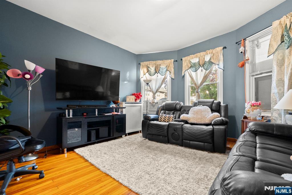 91 Headley Terrace Irvington, NJ 07111 - Photo 10 of 50 a living room with furniture and a flat screen tv