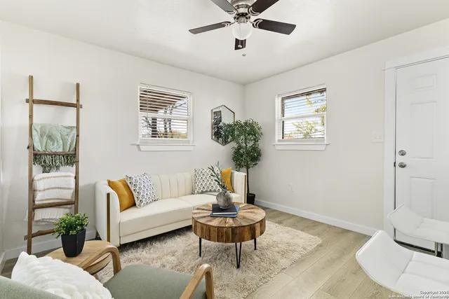 a living room with furniture and a potted plant