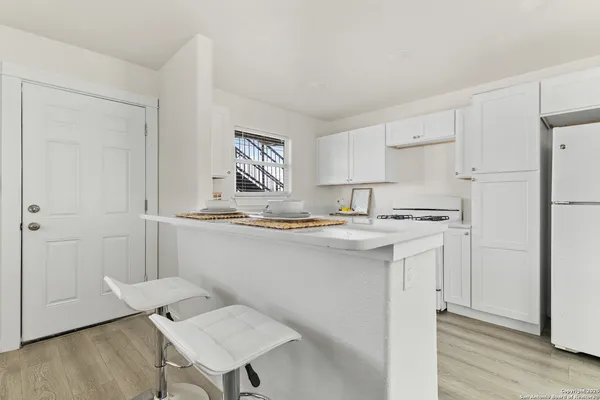 a kitchen with stainless steel appliances granite countertop a sink and a refrigerator