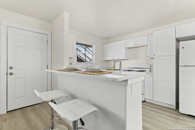 a kitchen with stainless steel appliances granite countertop a sink and a refrigerator