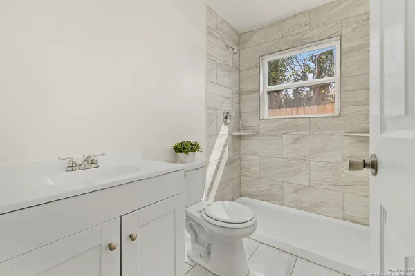 a bathroom with a toilet and a shower