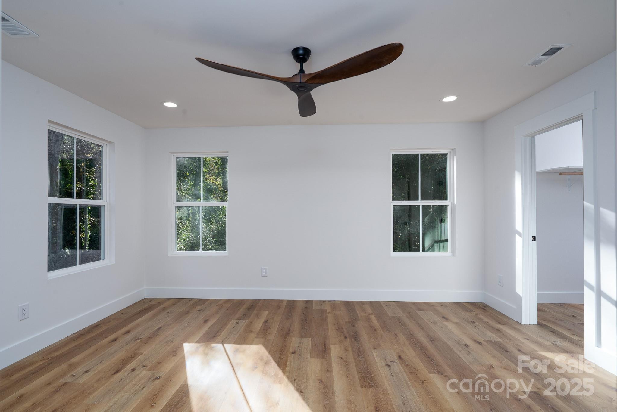 924 Oregon Street Kannapolis, NC 28083 - Photo 15 of 34 a view of an empty room with wooden floor and windows