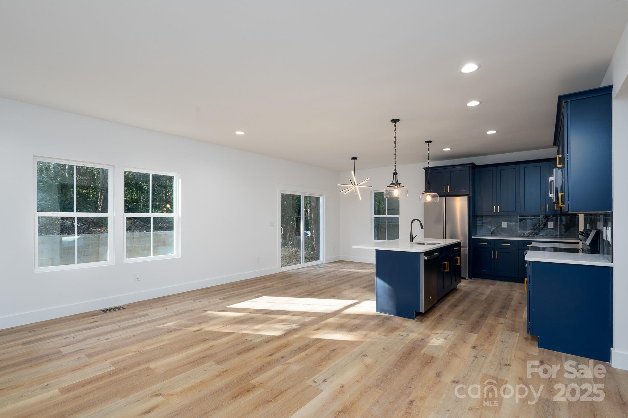 924 Oregon Street Kannapolis, NC 28083 - Photo 22 of 34 a view of kitchen with kitchen island wooden floor center island and stainless steel appliances