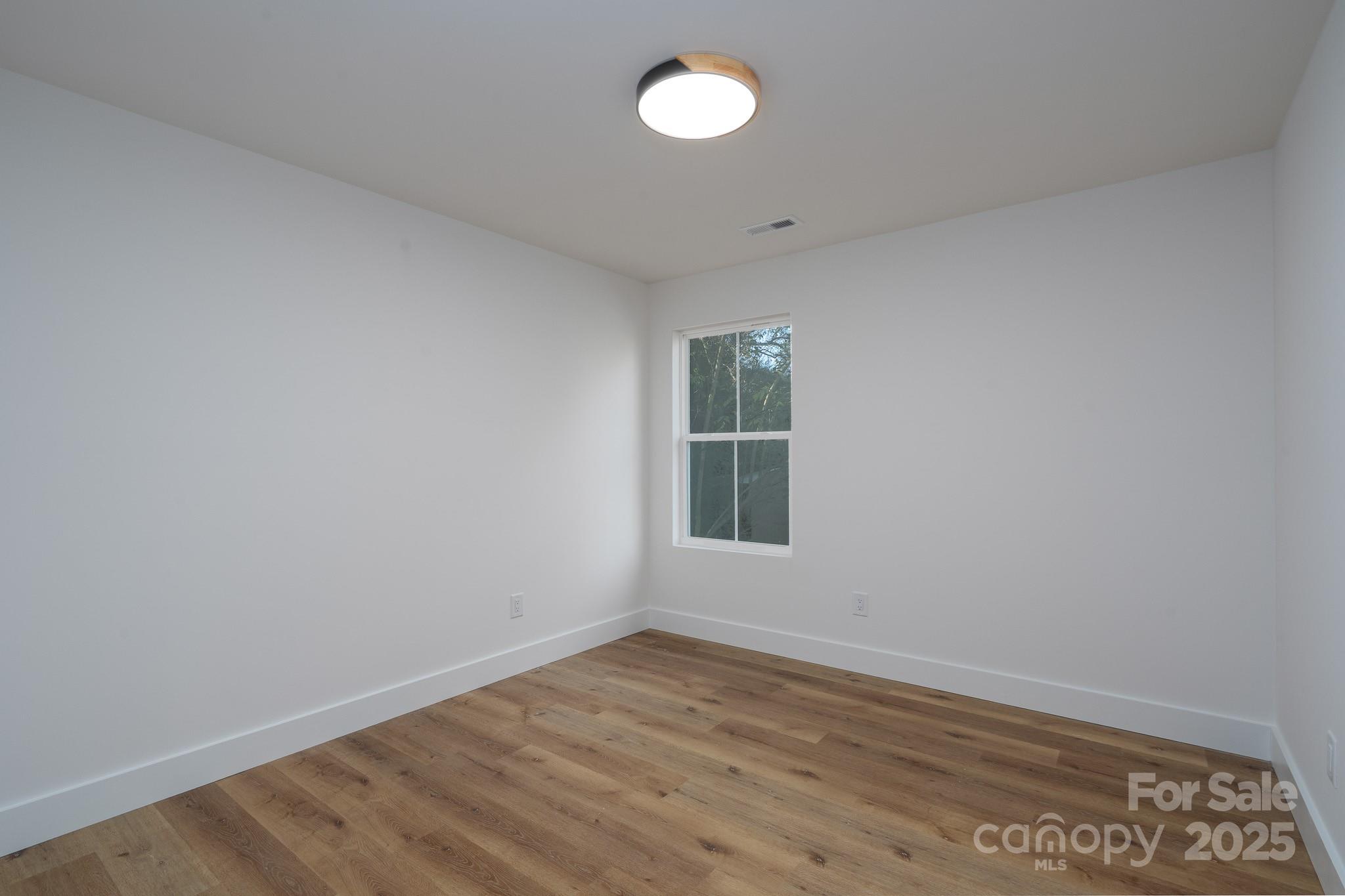 924 Oregon Street Kannapolis, NC 28083 - Photo 10 of 34 wooden floor in an empty room with a window