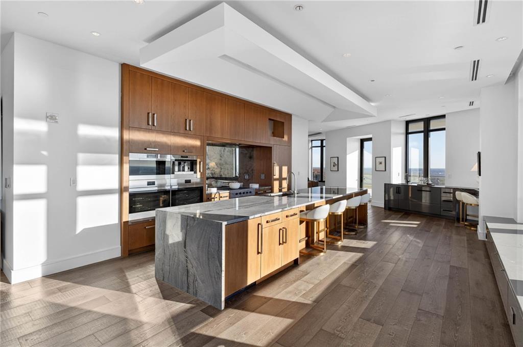 3376 Peachtree Road Northeast, Unit 57 & 58 Atlanta, GA 30326 - Photo 22 of 48 a large kitchen with stainless steel appliances kitchen island granite countertop a large counter top and stove