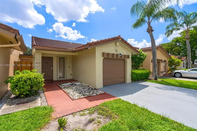 a front view of a house with garden