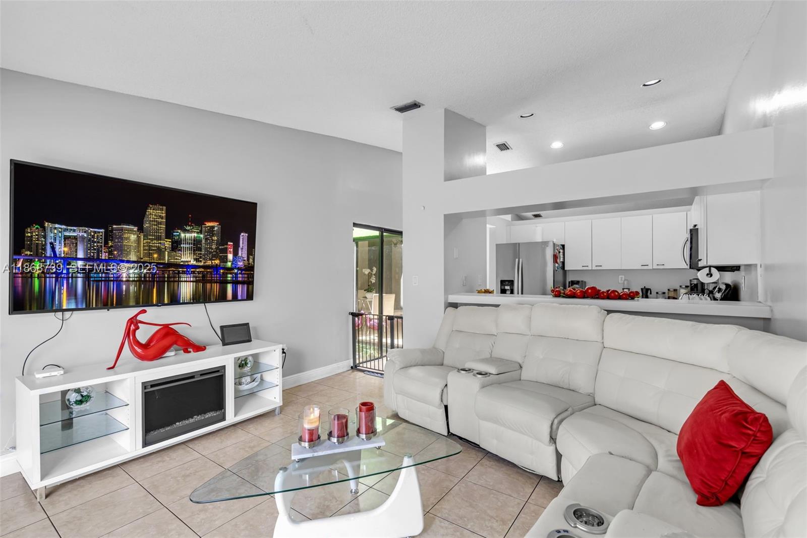 6646 Northwest 175th Terrace Hialeah, FL 33015 - Photo 12 of 33 a living room with furniture cabinets and a book shelf