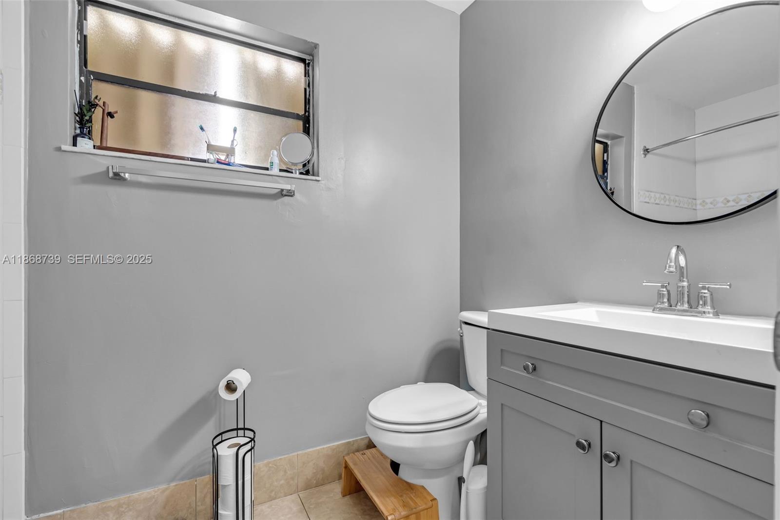 6646 Northwest 175th Terrace Hialeah, FL 33015 - Photo 16 of 33 a bathroom with a toilet a sink and mirror