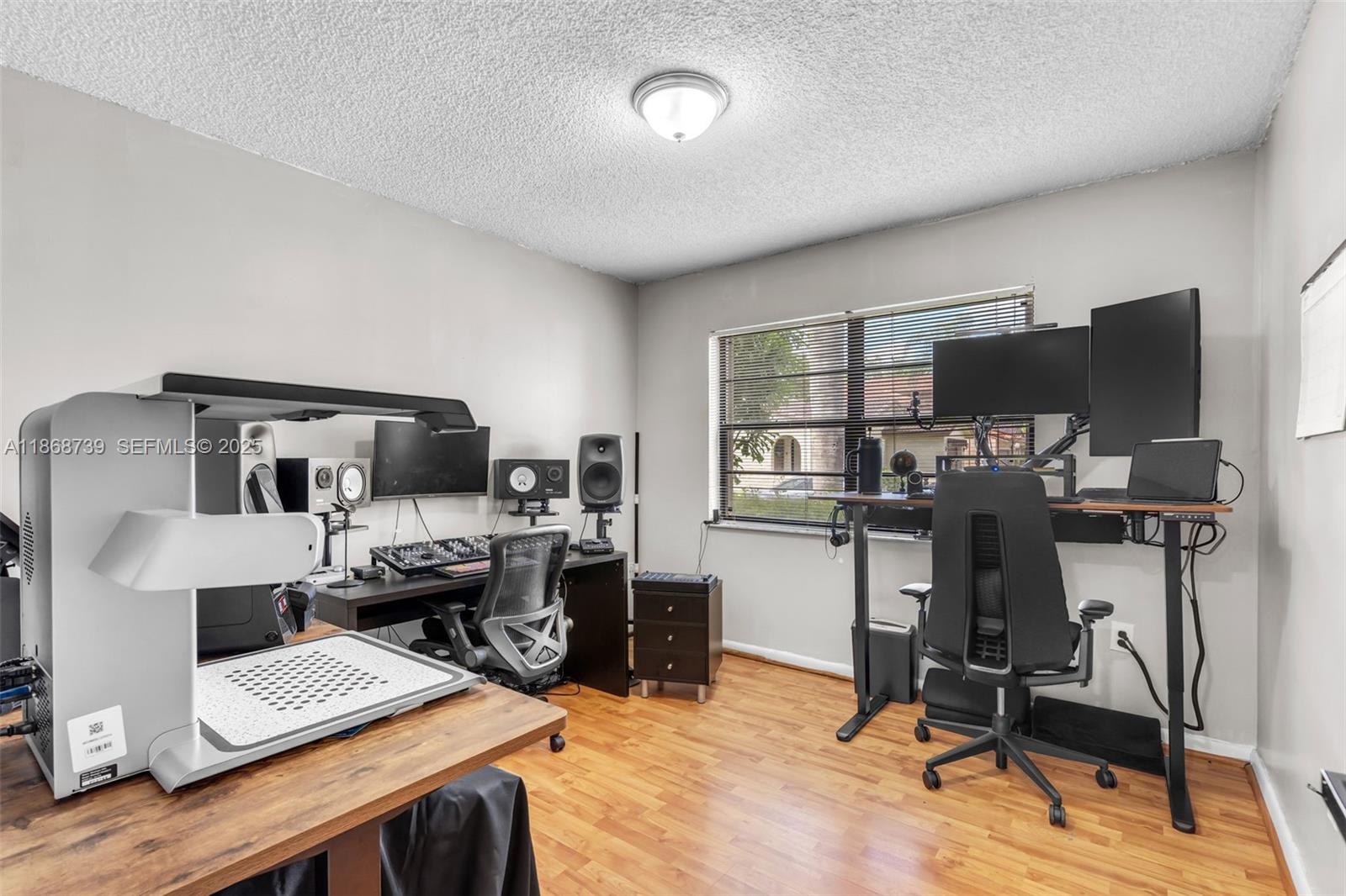 6646 Northwest 175th Terrace Hialeah, FL 33015 - Photo 20 of 33 a view of a workspace with furniture and a bedroom