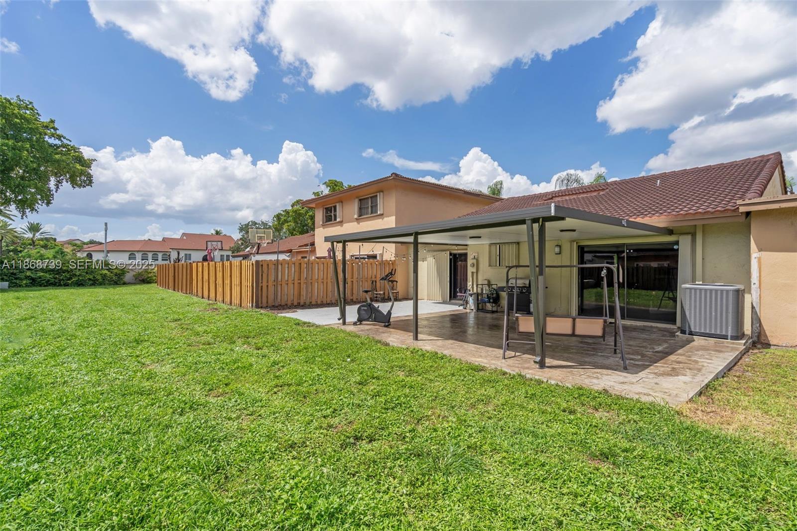 6646 Northwest 175th Terrace Hialeah, FL 33015 - Photo 22 of 33 a view of a house with a yard porch and sitting area