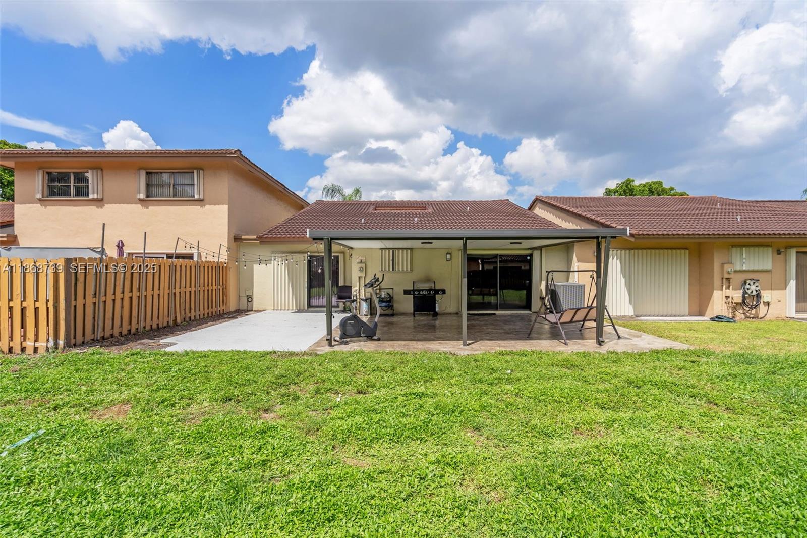 6646 Northwest 175th Terrace Hialeah, FL 33015 - Photo 23 of 33 a front view of a house with garden and porch
