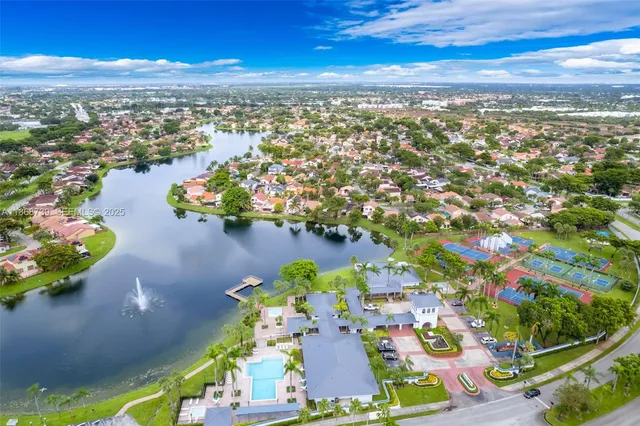 an aerial view of residential houses with outdoor space and swimming pool
