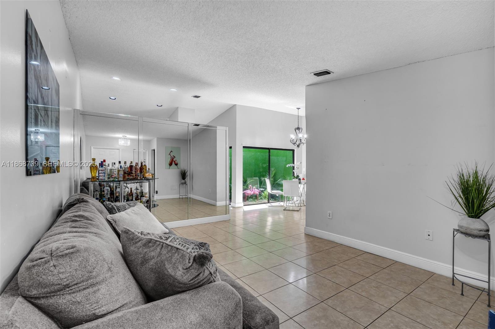 6646 Northwest 175th Terrace Hialeah, FL 33015 - Photo 4 of 33 a living room with furniture and a large window